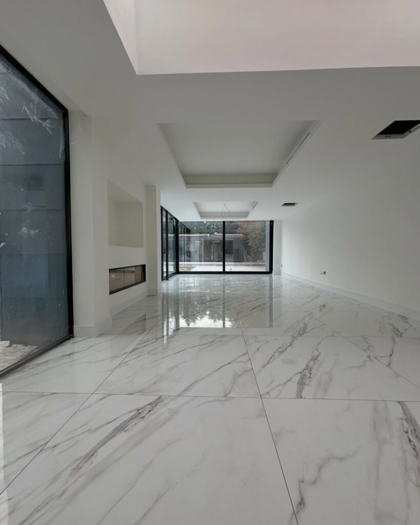Long hallway with polished large-format tile floor