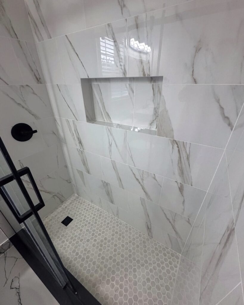 Marble-look shower wall with recessed niche