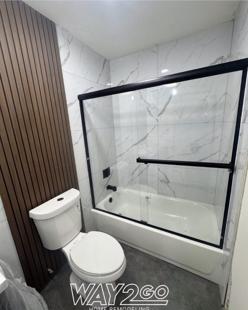 Tub and shower with black-framed glass door