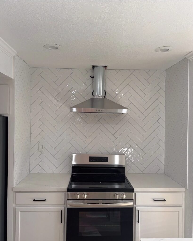 Kitchen with white herringbone backsplash