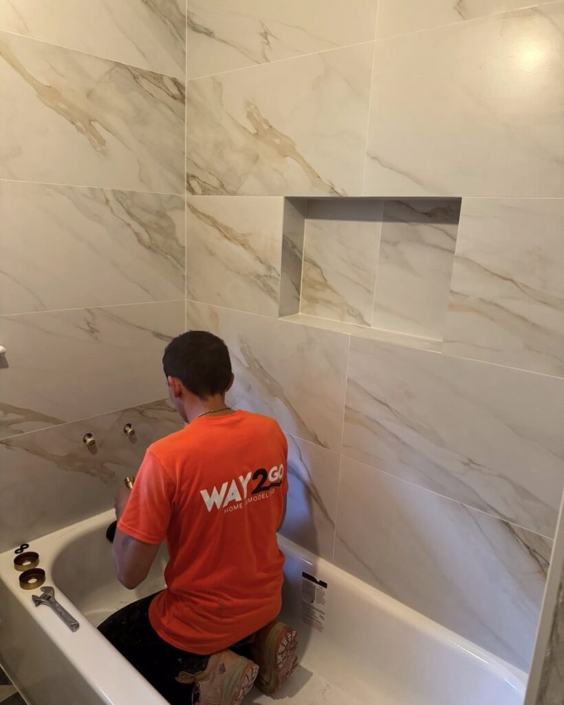 Tile setter installing a tub surround