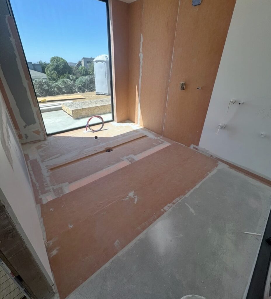 Bathroom prepped with orange waterproof membrane before tiling